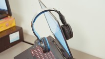 Headphones on a laptop computer in an office