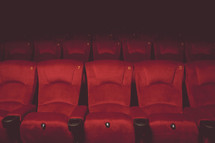 rows of red theater seats 