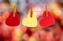 paper hearts on clothespins and bokeh background 