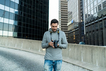 a man standing in a city holding a camera 