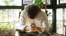 a man bowing his head in sincere prayer 