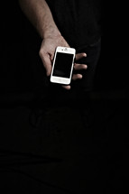 A hand holding an iphone