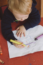 toddler boy drawing a snowman 