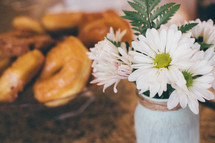 daisies in a vase and donuts 