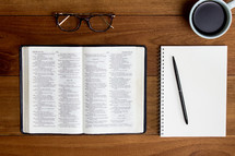 open Bible, coffee cup, and journal 