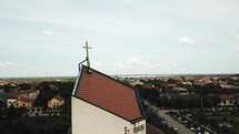 a drone shot over a church steeple 