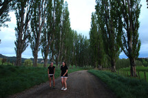 women jogging on a gravel road 