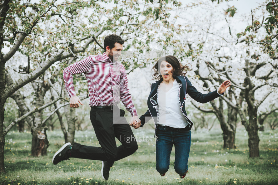 celebrating couple in an orchard 