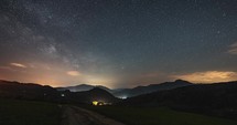 Starry night sky with Milky Way Galaxy in countryside landscape Astronomy Timelapse, Stars motion over country road
