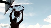 man dunking a basketball 