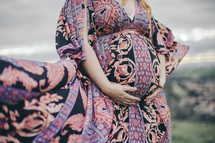 pregnant woman holding her belly 