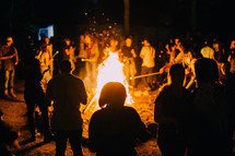 crowds around a bon fire 