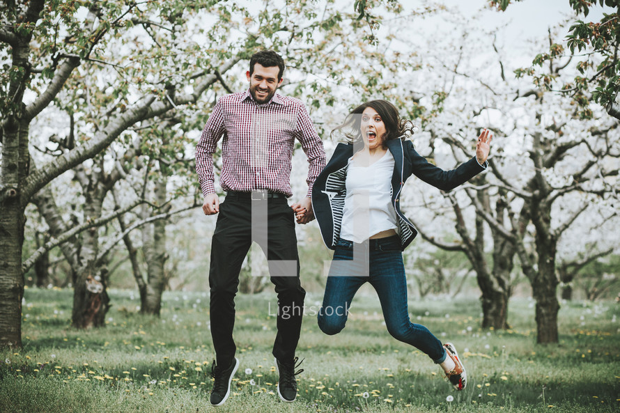 celebrating couple in an orchard 