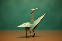 A close-up of an origami bird placed on a table