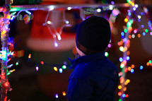 a boy admiring Christmas lights 