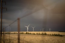 wind turbines in a stormy field 