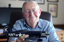 elderly man with a model airplane 