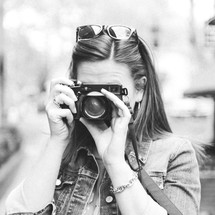 woman taking a picture with a camera 