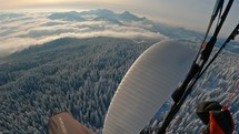 Paragliding adrenaline flying above winter wonderland, freedom outdoor adventure
