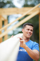 a volunteer building a house 