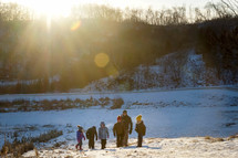 family walking in snow 