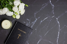 Bible on a black marble background 