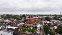 Aerial footage of a red brick church in St. Louis, Missouri on a cloudy/overcast day.