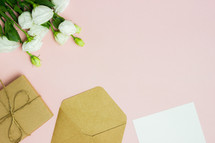 envelopes and white roses on pink 