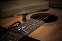 cross necklace, acoustic guitar, and Bible 
