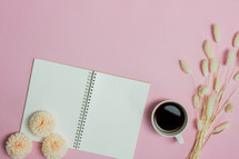 open notebook on a pink background 