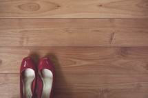 red dress shoes on a wood floor 