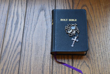 rosary on the cover of a Bible 