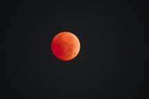 Lunar Eclipse - red moon surrounded by stars