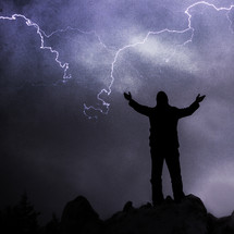 Man praising God in a lightning storm. God is in control of all things. He has power beyond our imagination. Trust in him through all of life's dark moments and you will not be let down.