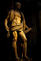 statue of a muscular man in a church 