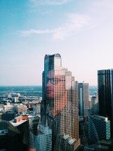 reflection of a man's face on a tall skyscraper 