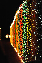 colorful christmas lights on a fence