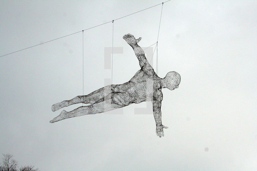 modern art wire man hanging in flight 