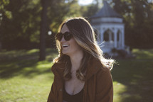 brunette woman wearing sunglasses outdoors 