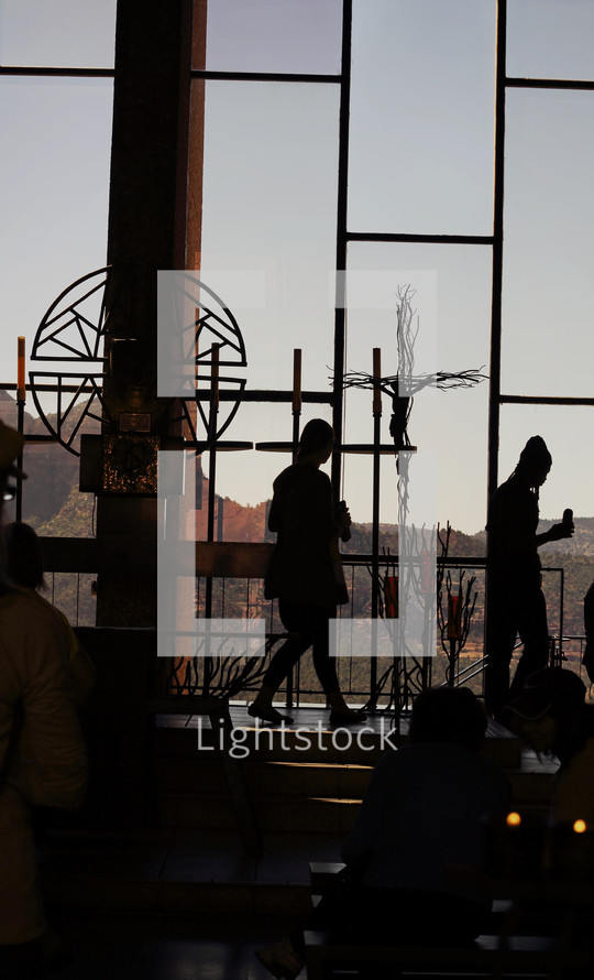silhouettes in glass chapel lighting candles