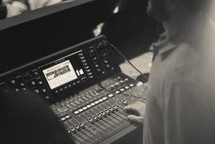 man controlling a soundboard 