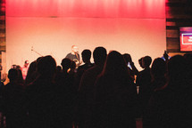 musicians on stage and youth in the audience 