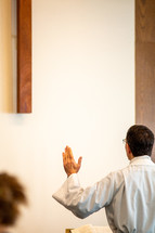 pastor with hands raised during prayers 