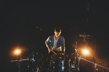 a man playing drums on stage 