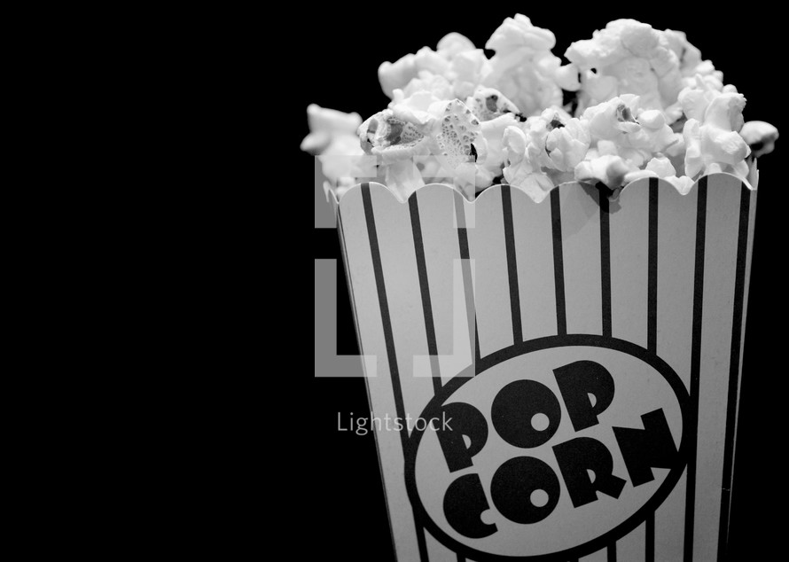 popcorn against a black background 