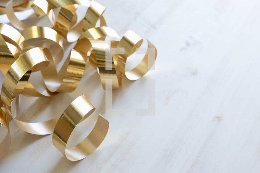 gold streamers on a white background