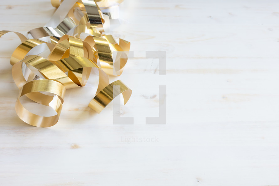 gold streamers on a white background