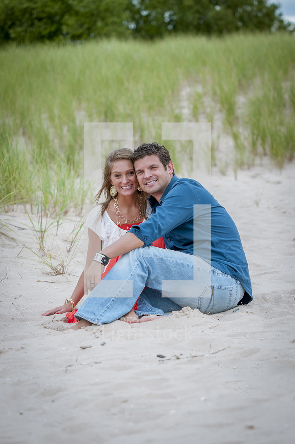portrait of a couple sitting on a beach 