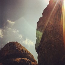 rays of sunlight on a rock peak
