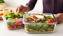 Healthy lunch box with chicken breast, salad and vegetables